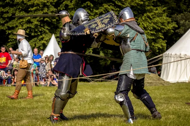 Regizarea unui duel cavaleresc cu sabia şi scutul din timpul unui turnir.