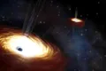 Astronomii au cântărit cea mai grea pereche de găuri negre descoperită vreodată