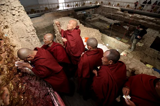 Călugări budişti se roagă la templul Maya Devi din Lumbini, Nepal
