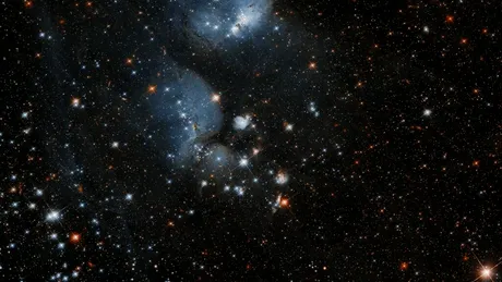 Telescopul Hubble a „tras cu ochiul” la coconii care formează stele într-o galaxie vecină